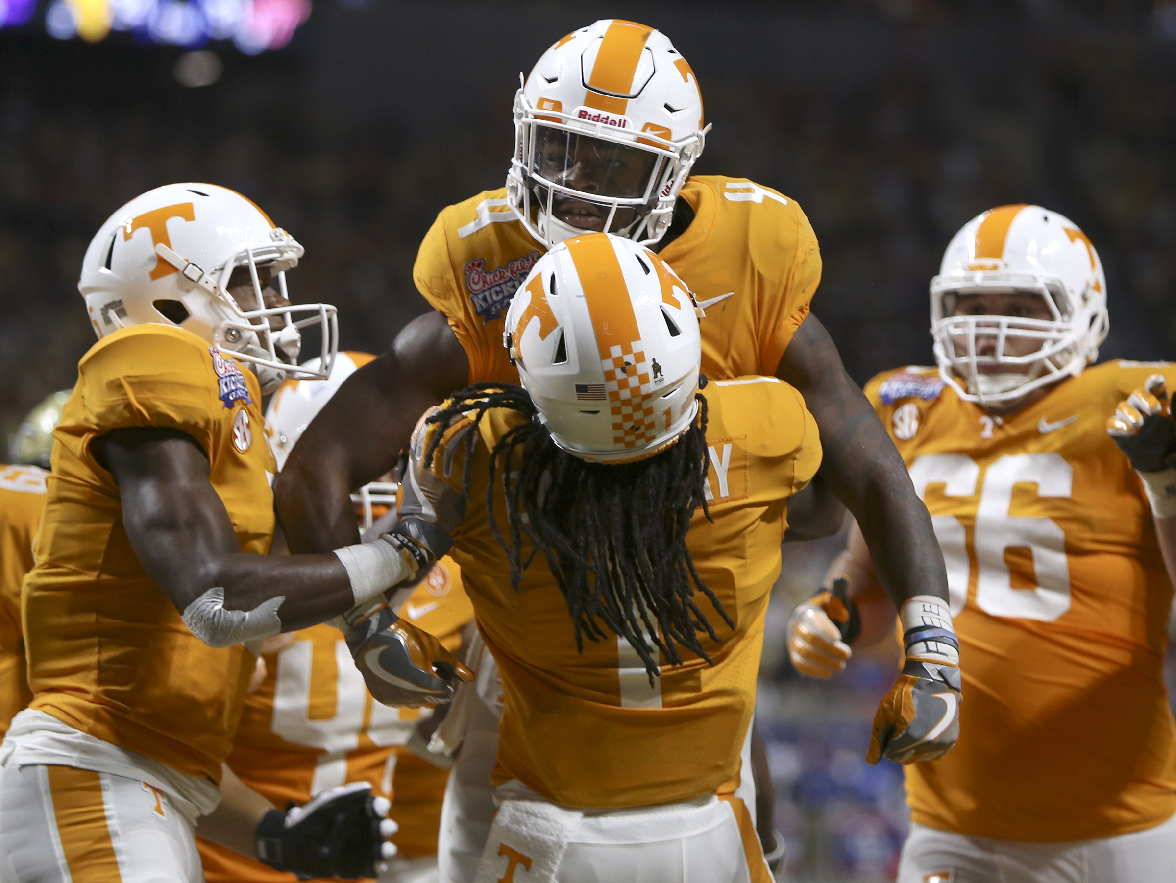 Tennessee wide receiver Marquez Callaway (1) picks up running back John Kelly (4) after Kelly's 1-yard touchdown run during the Chick-fil-A Kickoff Game at Mercedes-Benz Stadium on Monday, Sept. 4, in Atlanta, Ga.