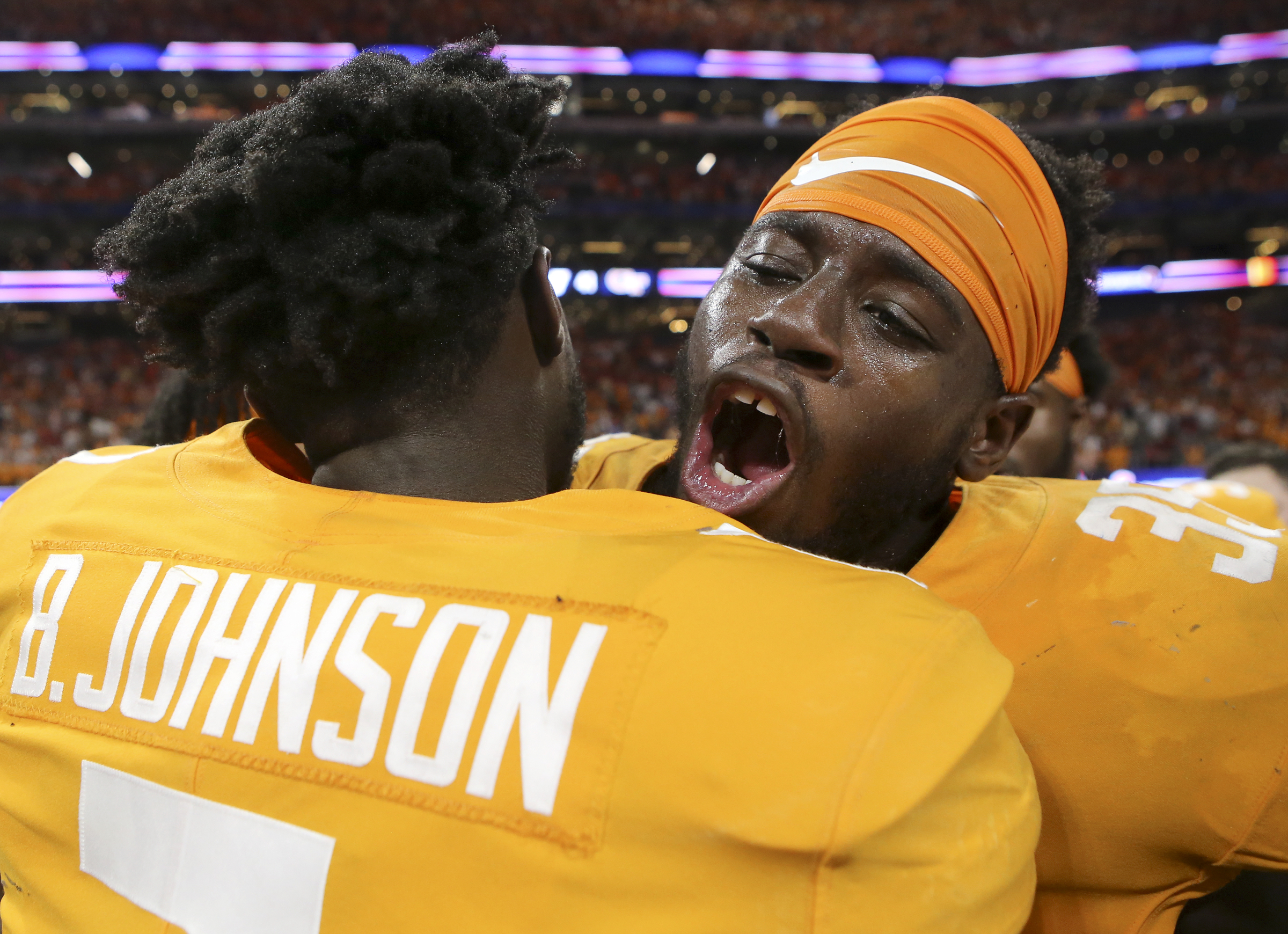 Tennessee linebacker Daniel Bituli, right, and wide receiver Brandon Johnson (7) celebrate after their double-overtime win over Georgia Tech in the Chick-fil-A Kickoff Game at Mercedes-Benz Stadium on Monday, Sept. 4, in Atlanta, Ga.