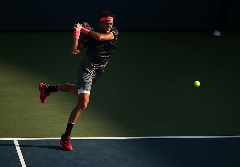 Juan Martin del Potro returns a shot from Dominic Thiem during the fourth round of the U.S. Open on Monday in New York. Del Potro rallied from two sets down to win in five, and he will face Roger Federer in the quarterfinals.