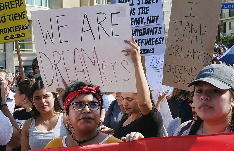 Supporters of the Deferred Action for Childhood Arrivals, or DACA, chant slogans and hold signs while joining a Labor Day rally in downtown Los Angeles on Monday. President Donald Trump has since announced he will end the program, but with a six-month delay. (AP Photo/Richard Vogel)