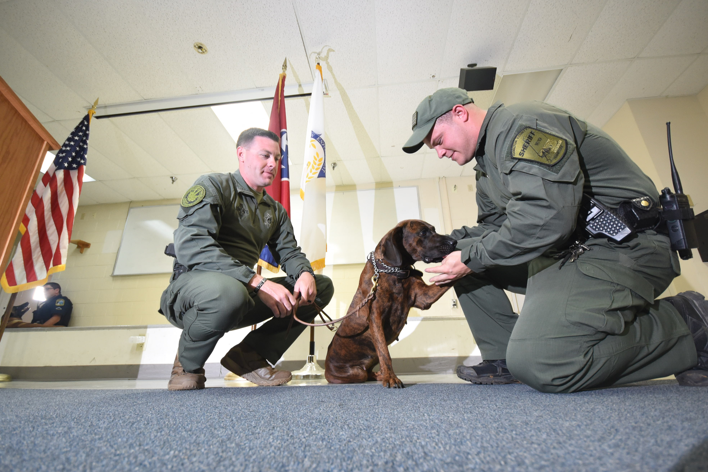 K-9 handlers Chris Walker, left, and Danny Stone flank Tynne, the newest member to the Hamilton County Sheriff's K-9 unit on Tuesday morning.