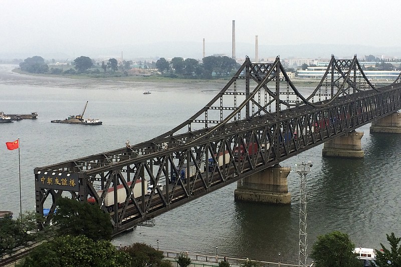
              FILE - In this Monday, Sept. 4, 2017, file photo, trucks crosses the friendship bridge connecting China and North Korea in the Chinese border town of Dandong, opposite side of the North Korean town of Sinuiju. China has long been the North’s main trading partner and diplomatic protector. But Kim Jong Un’s nuclear and missile tests have alienated Chinese leaders, who supported last month’s U.N. sanctions that slash North Korean revenue by banning sales of coal and iron ore. Beijing tried to head off the latest nuclear test, conducted Sunday, Sept. 3, 2017, by warning Pyongyang that such an event would lead to even more painful penalties. (AP Photo/Helene Franchineau, File)
            
