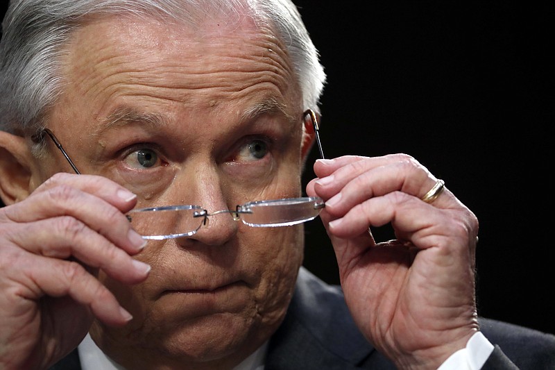 In this June 13, 2017, photo, Attorney General Jeff Sessions removes his glasses as he speaks on Capitol Hill in Washington, Twhile testifying before the Senate Intelligence Committee. Sessions, a son of the segregated South who was named after leaders of the Confederacy, faces a tough new test of his commitment to protecting civil rights as he oversees the Justice Department's probe of the deadly violence that erupted at a rally of white nationalists in Virginia. (AP Photo/Alex Brandon)