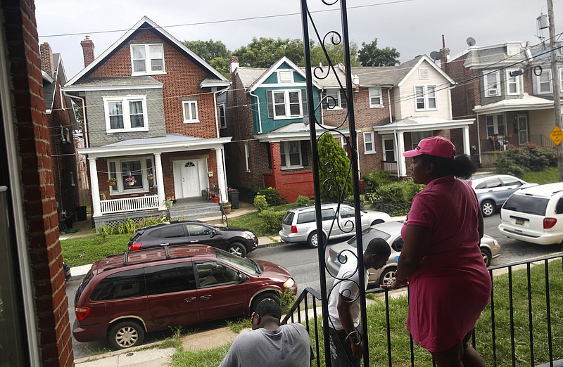 
              ADVANCE FOR USE FRIDAY, SEPT. 8, 2017 AND THEREAFTER-In this July 27, 2017 photo, Maria Williams stands on her front porch in Wilmington, Del., the day after her teenage son and daughter were shot and wounded while standing on the same porch. As she took cover inside and heard her kids' screams, "All I could think of was, 'I'm not losing another child,'" Williams recalled. Her 18-year-old stepson had been gunned down two years before, another victim of Wilmington's plague of teens shooting teens. His shooter was 17. (AP Photo/Patrick Semansky)
            