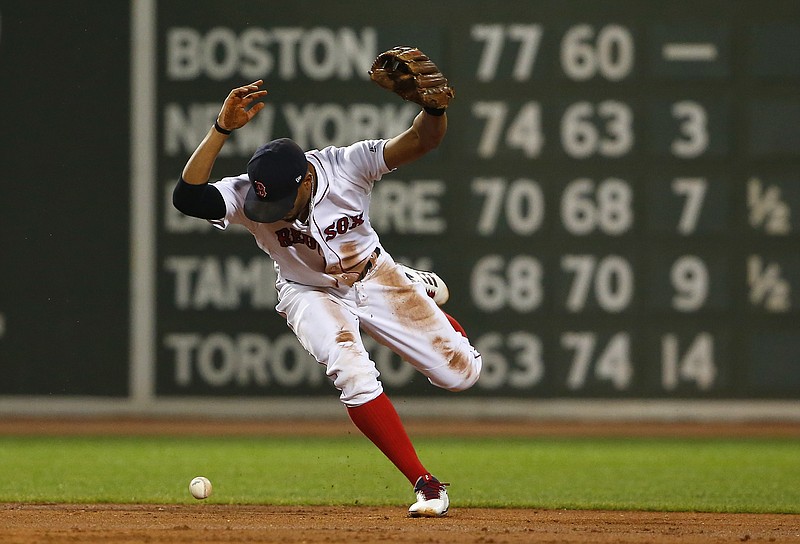 
              Boston Red Sox shortstop Xander Bogaerts loses the ball trying to force out a runner at second base during the second inning of a baseball game against the Toronto Blue Jays at Fenway Park in Boston, Monday, Sept. 4, 2017. (AP Photo/Winslow Townson)
            