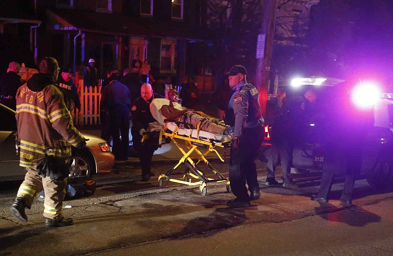 
              ADVANCE FOR USE FRIDAY, SEPT. 8, 2017 AND THEREAFTER-In this Friday, Jan. 15, 2015 photo, emergency workers use a stretcher to bring a shooting victim into an ambulance at West 4th and Broom Streets in Wilmington, Del., after gunshots claimed multiple victims. A 16-year-old who had been shot in the head died at the hospital, according to police. (William Bretzger/The Wilmington News-Journal via AP)
            