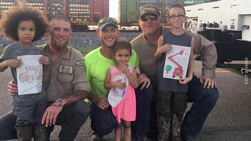 Bloomington, Texas, resident Suanne Fox last Thursday snapped a photo of lineman Lachlan Brain, adult on the right, and her children, from left, Kayden, 4, Riley, 2, and Ryan Jr., 7, where Brain and coworkers, from left J.J. Bilyeau and Matthew Collins, were working to restore power to storm-stricken residents. Brain died Tuesday after being electrocuted while working on power lines in the Crescent Valley community just a few miles north of Bloomington.