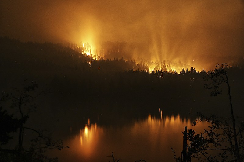 
              A wildfire continues to burn on the Oregon side of the Columbia River Gorge near Cascade Locks, Ore., and the Bridge of the Gods, late Tuesday, Sept. 5, 2017. (Genna Martin/seattlepi.com via AP)
            