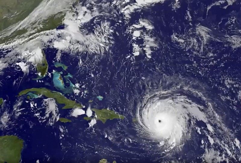 
              In this GOES-13 satellite image taken Wednesday, Sept. 6, 2017 at 7:15 a.m. EDT, and released by NASA/NOAA GOES Project, Hurricane Irma tracks over Saint Martin and the Leeward Islands. Hurricane Irma roared into the Caribbean with record force early Wednesday, its 185-mph winds shaking homes and flooding buildings on a chain of small islands along a path toward Puerto Rico, Cuba and Hispaniola and a possible direct hit on densely populated South Florida.  (NASA/NOAA GOES Project via AP)
            