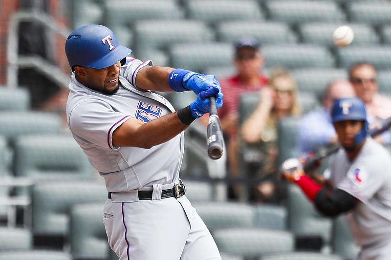 Texas Rangers' Elvis Andrus (1) hits a solo home run in the first inning of the first game of a baseball doubleheader against the Atlanta Braves, Wednesday, Sep. 6, 2017, in Atlanta. (AP Photo/Todd Kirkland)