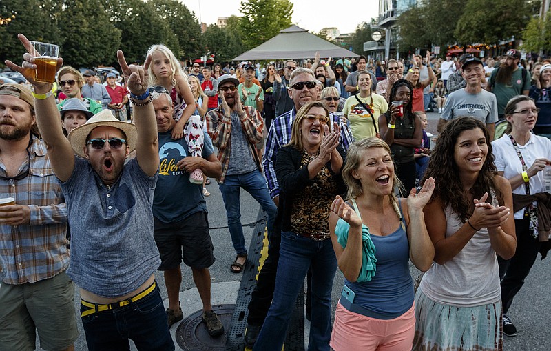 Fans cheer for local ban Strung Like a Horse during the Made in Tennessee Celebration on Broad Street in front of the Tennessee Aquarium on Wednesday, Sept. 6, 2017, in Chattanooga, Tenn. The celebration, which featured celebrations of southern cuisine and free live music, was the first of several events leading to the Ironman 70.3 World Championship triathlons held on Saturday and Sunday.