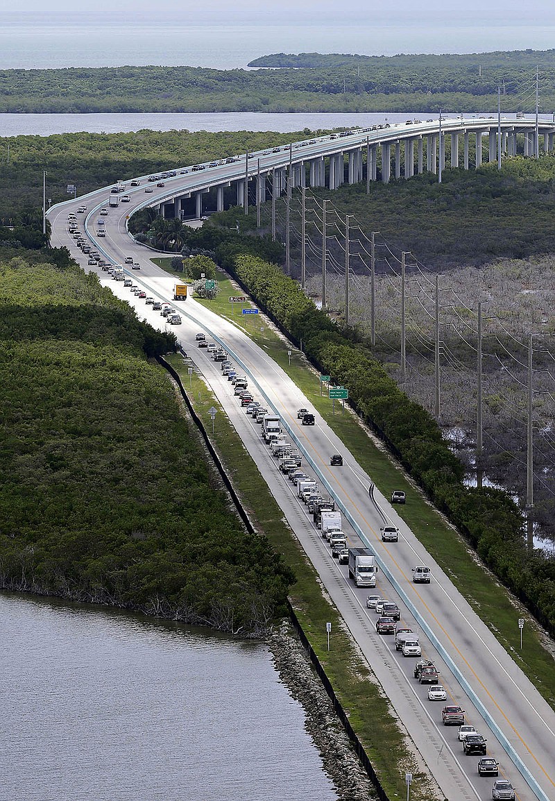 Motorists head north on US 1, Wednesday, Sept. 6, 2017, in Key Largo, Fla., in anticipation of Hurricane Irma.  Keys officials announced a mandatory evacuation Wednesday for visitors, with residents being told to leave the next day. (AP Photo/Alan Diaz)