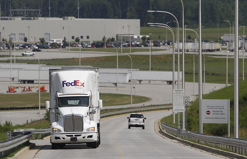 Staff File Photo by Dan Henry / Motorists travel the private Ferdinand Piech Way that leads to Volkswagen's supplier park. State road builders are working on the last section of a public highway that will directly connect I-75 with Highway 58 through the VW plant site.