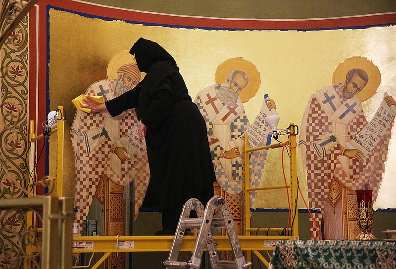 Mother Teodora Balaban wipes down portions of the iconography that she has been working on the alter of the Annunciation Greek Orthodox Church in Chattanooga, Tenn., on Thursday, Aug. 24, 2017. Katsaros was enlisted by the church to paint the moment when the angel Gabriel announced to the Virgin Mary her conception of Christ.