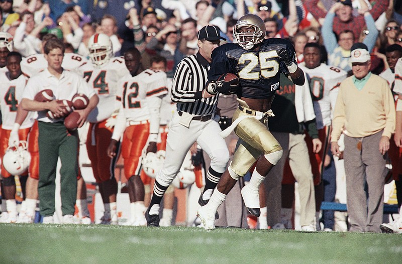 Notre Dame?s Raghib ?Rocket? Ismail flies down the sideline accompanied by only the referee during first half action, Oct. 20, 1990 in South Bend. Rocket returned the Hurricane kickoff 94 yards for an Irish touchdown. (AP Photo/Mark Elias)
