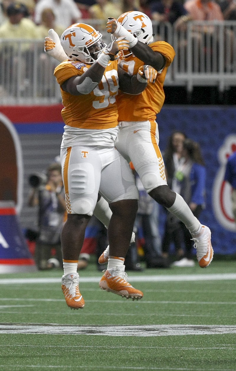 Tennessee defensive linemen Darrell Taylor (19) and Reginald McKenzie Jr. (99) celebrate a stop against Georgia Tech during the Chick-fil-A Kickoff Game at Mercedes-Benz Stadium on Monday, Sept. 4, in Atlanta, Ga.