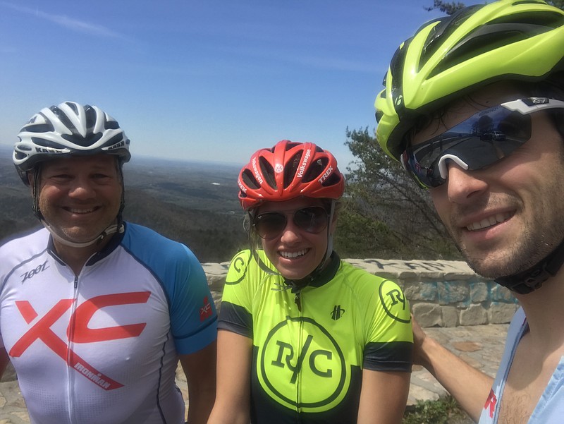 From left, Johnny O'brien, Molly Wiygul and John Wiygul pose for a photo during a training ride for the Ironman 70.3 World Championships.