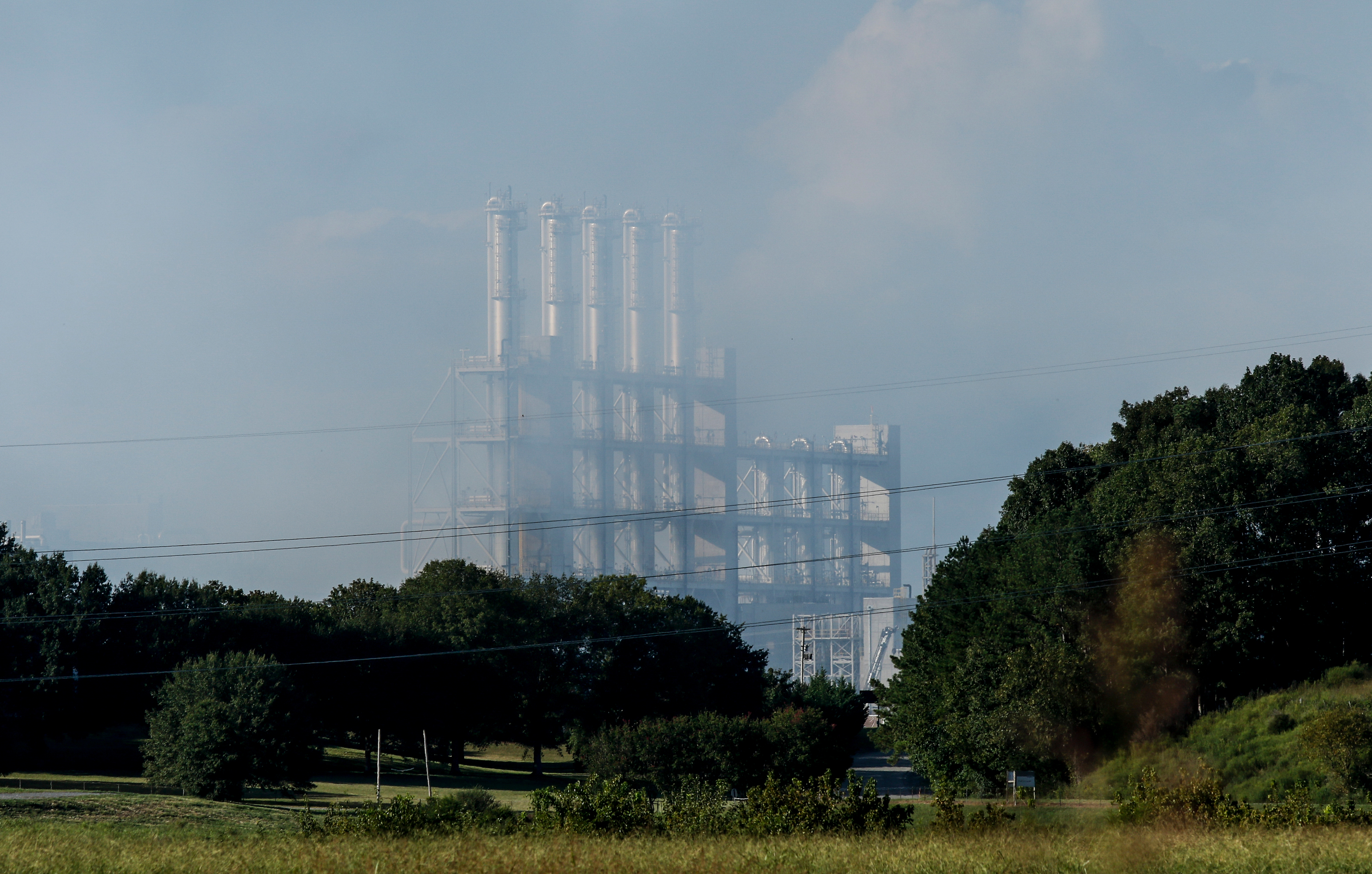 The Wacker polysilicon chemical plant is barely visible through haze after an explosion released a hydrogen chemical gas on Thursday, Sept. 7, 2017, in Charleston, Tenn. The explosion closed the plant, but a statement from Wacker says air quality was unaffected.