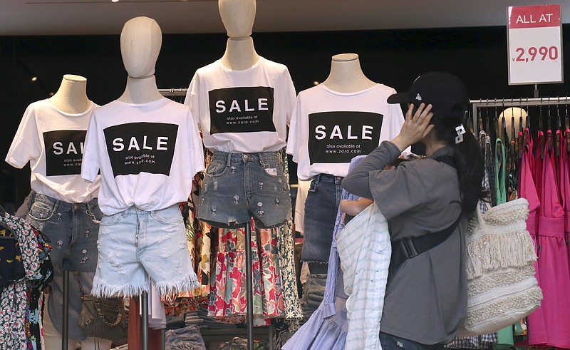 
              FILE - In this June 29, 2017 file photo, shoppers choose clothes at a store in Tokyo's Omotesando shopping district. The Japanese economy grew at a slower pace in the April-June quarter, not the surprisingly strong spurt indicated by an earlier estimate, according to revised government data Friday, Sept. 8, although signs of a revival are holding up. (AP Photo/Shizuo Kambayashi, File)
            