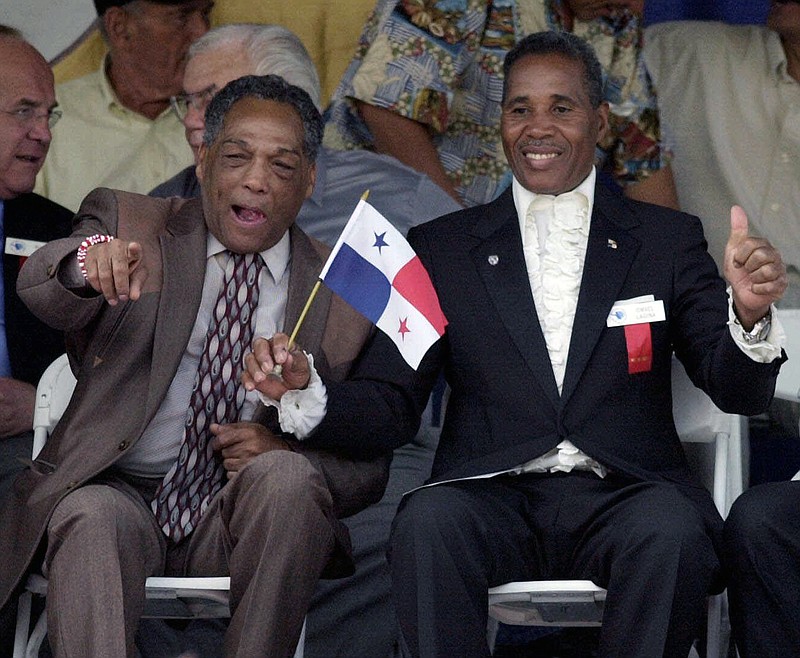 
              FILE - In this June 10, 2001, file photo, International Boxing Hall of Fame inductees Sugar Ramos of Mexico, front left, and Ismael Laguna of Panama, gesture during induction ceremonies in Canastota, N.Y. Ramos, the Cuban featherweight champion whose fists led to two deaths in the ring, has died in Mexico City. He was 75. The World Boxing Council said he died Sunday, Sept. 3, 2017, of cancer. (AP Photo/Kevin Rivoli, File)
            