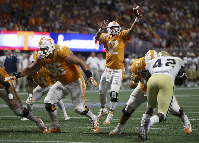 Tennessee quarterback Quinten Dormady (12) pulls down a snap during the Chick-fil-A Kickoff Game against Georgia Tech at Mercedes-Benz Stadium on Monday, Sept. 4, in Atlanta, Ga.