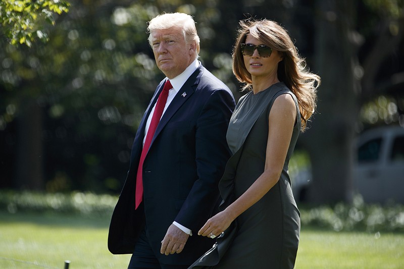 
              President Donald Trump walks with first lady Melania Trump to board Marine One on the South Lawn of the White House, Friday, Sept. 8, 2017, in Washington. (AP Photo/Evan Vucci)
            
