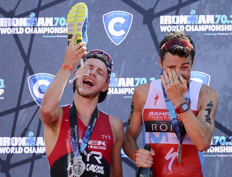 America's Ben Kanute, left, and Spain's Javier Gomez celebrate after finishing second and first, respectively, during the Icy Hot Ironman 70.3 World Championship on Sunday, Sept. 10, in Chattanooga, Tenn.