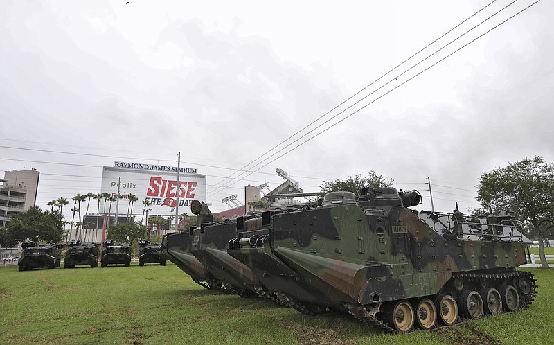 
              National Guard amphibious vehicles stage at Raymond James Stadium Sunday, Sept. 10, 2017, in Tampa, Fla., as Hurricane Irma continues to churn towards the state. As Irma marches up Florida's Gulf Coast toward Tampa Bay, residents fear what the storm will do to an area that hasn't taken a direct hit from a major hurricane since 1921. (AP Photo/Chris O'Meara)
            