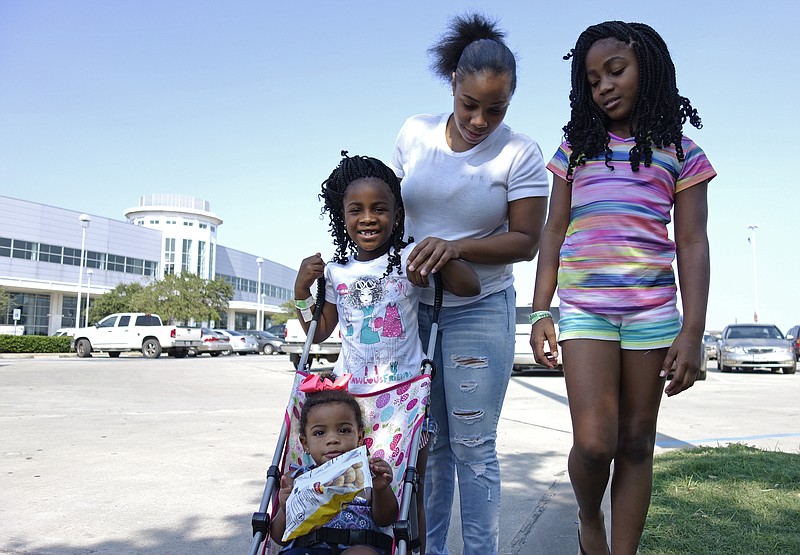 
              In this Sept. 6, 2017 photo, Tori Texada, 25, Chloe, 7, in right, Maddison, 6, and Paisley, 1, pose for photo outside of the shelter at a convention center in Houston. The single-mother of five, including three who are school-aged, said she wanted to get her kids back to their neighborhood school but that she hadn't yet been in touch with Houston district officials. State and federal law provides education assistance for homeless children. But it comes with hurdles _ information, access and funding _ that will be exacerbated and widespread in Houston and elsewhere after Harvey. (AP Photo/Brian Melley)
            