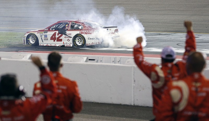 The pit crew for Kyle Larson (42) celebrates after winning the NASCAR Cup Series auto race at Richmond International Raceway in Richmond, Va., Saturday, Sept. 9, 2017. (AP Photo/Steve Helber)
