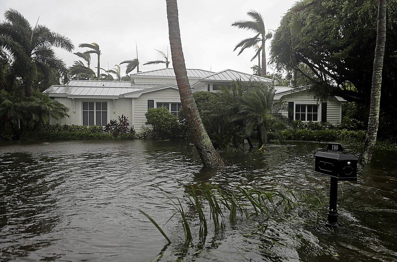 A houses is surrounded by water as Hurricane Irma passes through Naples, Fla., Sunday, Sept. 10, 2017. (AP Photo/David Goldman)