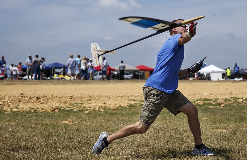 At last year's air show, Neil Baker throws a discus launch glider, which is radio controlled and uses air currents to remain aloft instead of a motor.