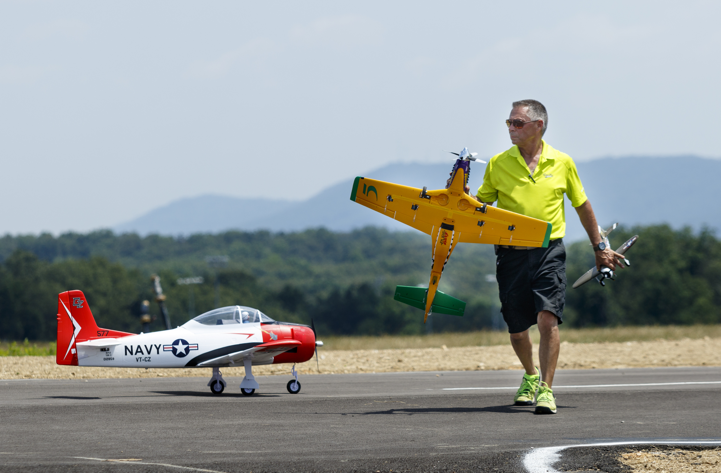 Tony Bosco carries an RC airplane from the runway at the fifth annual Siskin Children's Institute Air Show. The annual event features a variety of radio controlled aircraft.