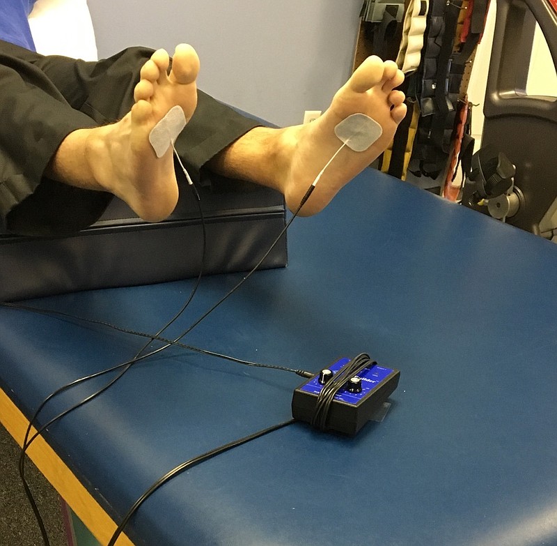 A patient receives treatment for neuropathy in their feet at Rehab South Physical Therapy in Hixson. The electrical signals the machine puts out are almost imperceptible to the patient, and they trigger nerve ending regeneration, said physical therapist and owner Charlie Jones. (Contributed photo)