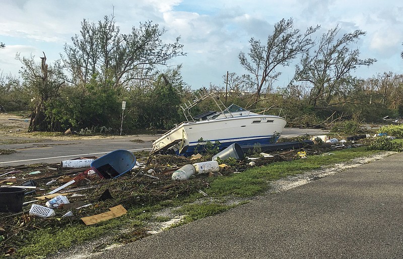 This image released by the Monroe County Board of County Commissioners shows debris along the Overseas Highway in the Florida Keys, Fla., Monday, Sept. 11, 2017. Recovery along the island chain continues after Hurricane Irma made landfall on Sunday as a Category 4 hurricane then. (Sammy Clark/Monroe County Board of County Commission via AP)