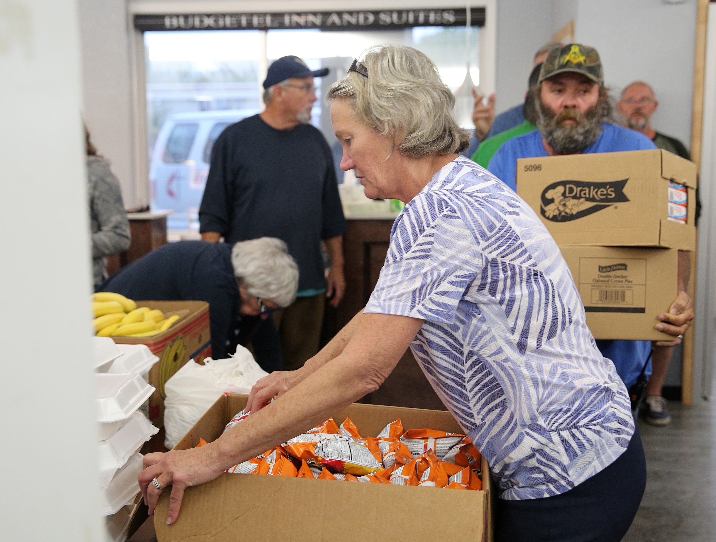 Joy Millen and others unload food donated for those fleeing Florida from Hurricane Irma Monday, Sept. 11, 2017, at the Budgetel Inn in East Ridge, Tenn. Several businesses and local churches donated food to those fleeing the storm.