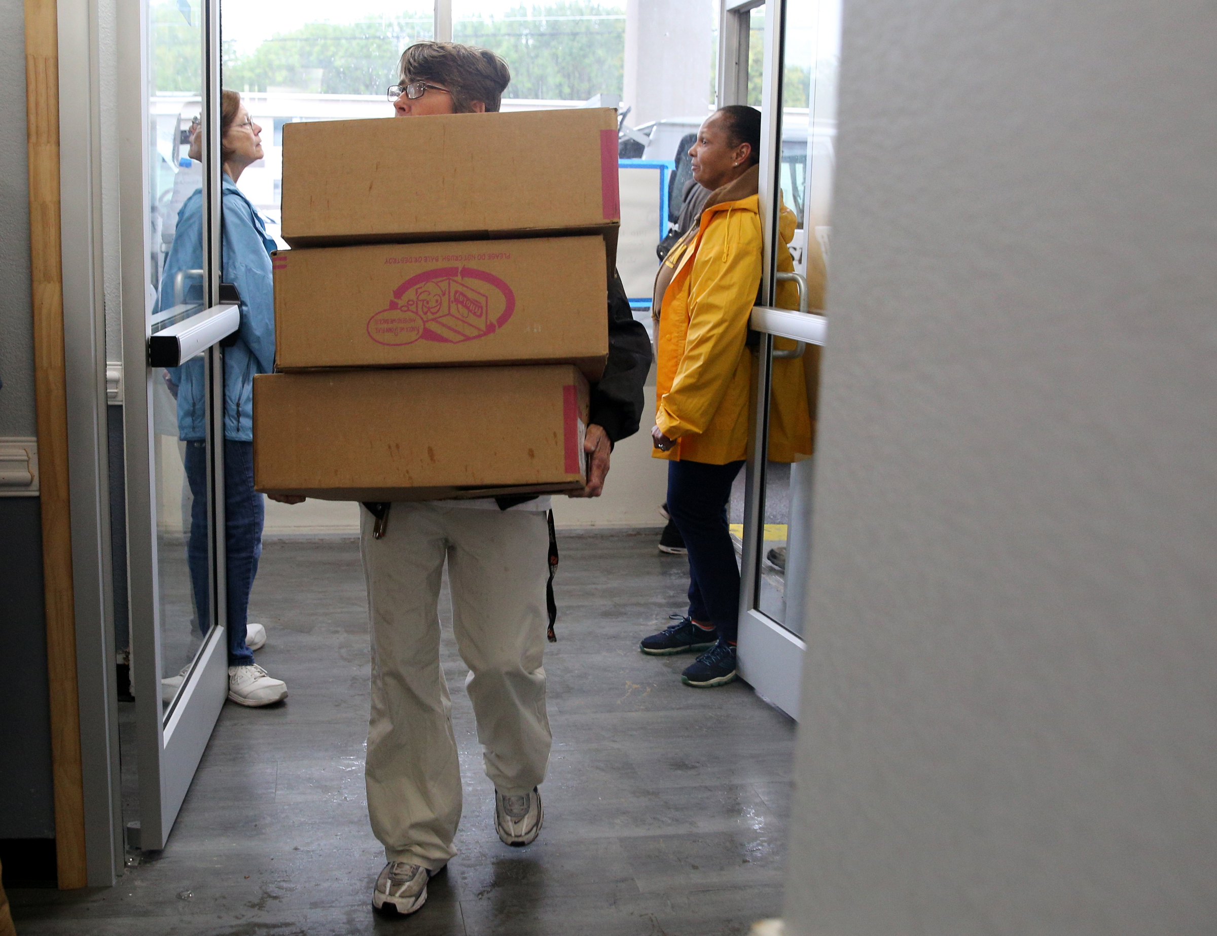 Martha Johnson of Belle Glade, Fla., carries several boxes of donated food items into Budgetel Inn in East Ridge, Tenn., Monday, Sept. 11, 2017. Johnson was one of many who caravanned with family to get out of the path of Hurricane Irma.