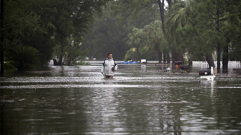 Joey Spalding walks back to his truck down the street where he lives, Monday, Sept. 11, 2017, on Tybee Island, Ga. Spalding just finished repairing his house from nine inches of water after Hurricane Matthew past the island last year. He said the Tropical Storm Irma brought three feet of storm surge into his living room today. (AP Photo/Stephen B. Morton)