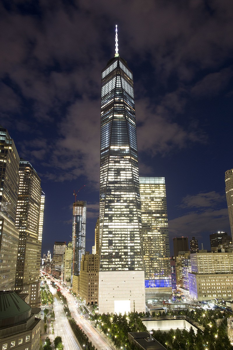 
              In this Friday, Sept. 8, 2017 photo, One World Trade Center overlooks the north reflecting pool of the National September 11 Memorial in New York. Monday will mark the sixteenth anniversary of the terrorist attacks. (AP Photo/Mark Lennihan)
            