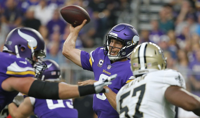 Minnesota Vikings quarterback Sam Bradford, center, throws a pass during the first half of an NFL football game against the New Orleans Saints, Monday, Sept. 11, 2017, in Minneapolis. (AP Photo/Bruce Kluckhohn)