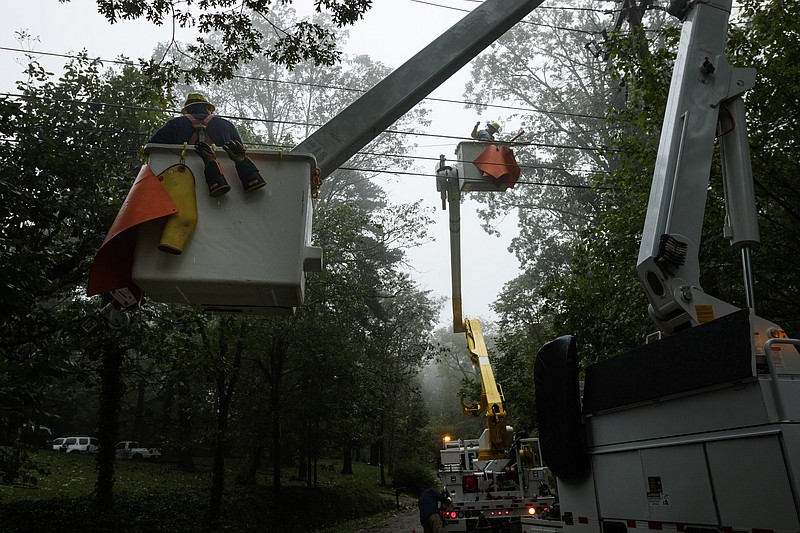 Linemen with EPB work to restore power on Tuesday, Sept. 12, 2017, in Signal Mountain, Tenn. After devastating Florida, hurricane Irma brought heavy rains and high winds to the Chattanooga region, felling trees and leaving homes without power.