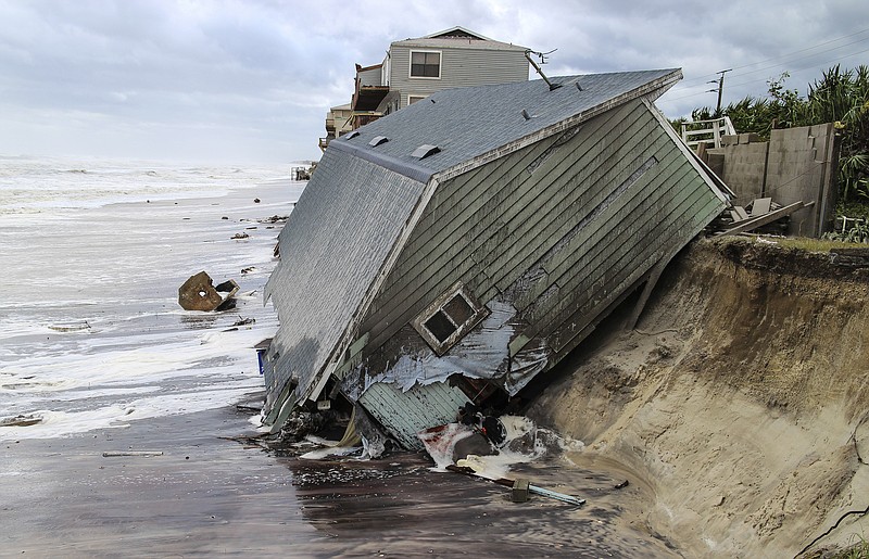 
              A house slides into the Atlantic Ocean in the aftermath of Hurricane Irma in Ponte Vedra Beach, Fla., Monday, Sept. 11, 2017. (Gary Lloyd McCullough/The Florida Times-Union via AP)
            