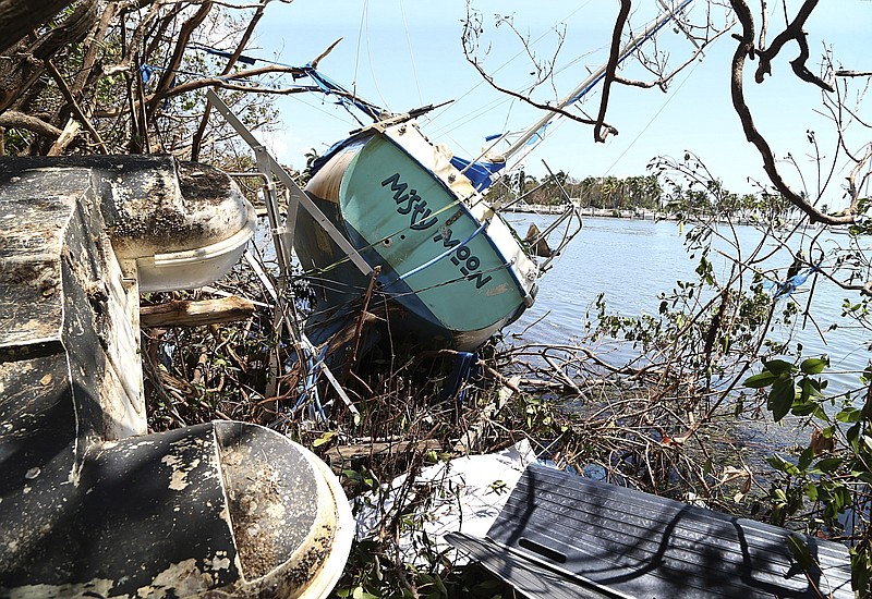 
              A damaged sail boat washed ashore is seen at Grove Key Marina after Hurricane Irma, Tuesday, Sept. 12, 2017, in Miami. (Pedro Portal/Miami Herald via AP)
            