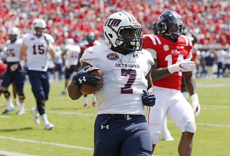UT-Martin running back Ladarius Galloway finishes a 4-yard touchdown run ahead of Ole Miss defensive end Victor Evans this past Saturday in Oxford, Miss.