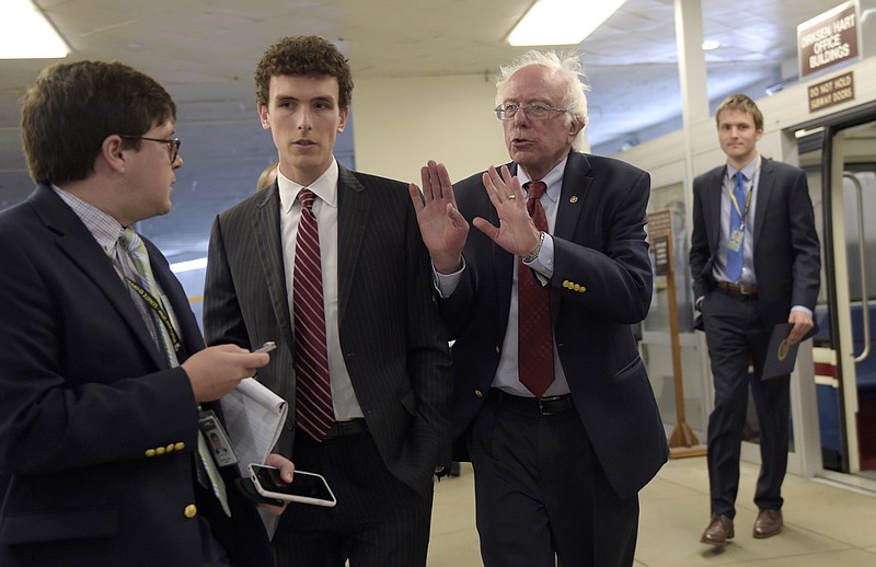 
              Sen. Bernie Sanders, I-Vt., second from right, declines to speak with a reporter as he walks to a luncheon with Democrats on Capitol Hill in Washington, Tuesday, Sept. 12, 2017. (AP Photo/Susan Walsh)
            