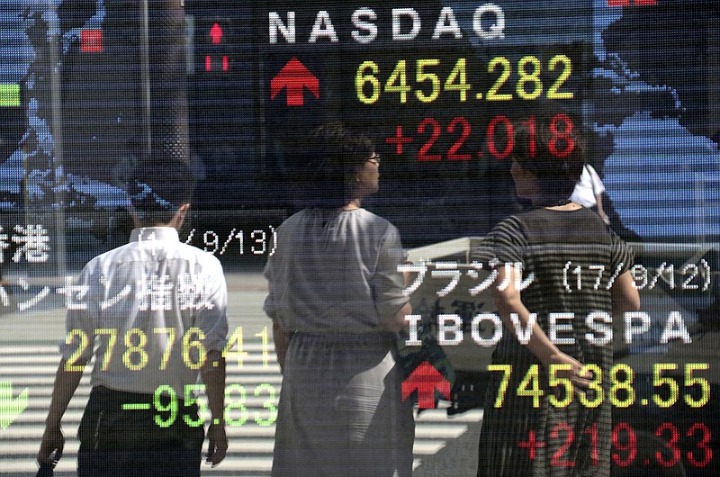 
              People are reflected on an electronic stock indicator of a securities firm in Tokyo, Wednesday, Sept. 13, 2017. Most Asian stock markets were higher Wednesday after U.S. shares rose on encouraging jobs data while worries about North Korea and twin hurricane disasters eased. (AP Photo/Shizuo Kambayashi)
            