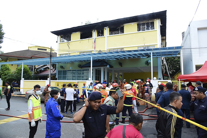 
              Police and rescue personnel work at an Islamic religious school cordoned off after the fire on the outskirts of Kuala Lumpur  Thursday, Sept. 14, 2017.  A fire department official in Malaysia said a fire at the Islamic religious school has killed people, mostly teenagers. (AP Photo)
            