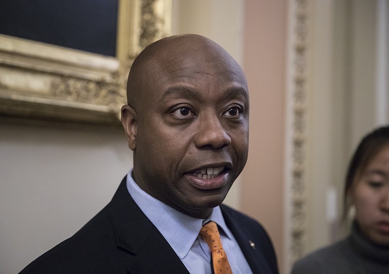 
              Sen. Tim Scott, R-S.C., the only African-American Republican serving in the Senate, talks to reporters about his plan to meet with President Donald Trump to discuss race and Trump's widely criticized response to last month's protests and racial violence in Charlottesville, Va., at the Capitol in Washington, Wednesday, Sept. 13, 2017. (AP Photo/J. Scott Applewhite)
            