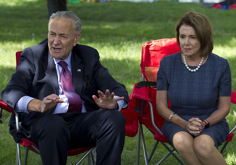 In this Sept. 7, 2017, photo, Senate Minority Leader Chuck Schumer of N.Y., accompanied by House Minority Leader Nancy Pelosi of Calif. speak Capitol Hill in Washington.