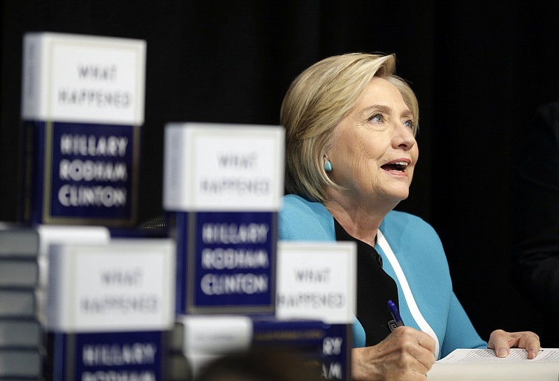 
              Hillary Rodham Clinton signs copies of her book "What Happened" at a book store in New York, Tuesday, Sept. 12, 2017. (AP Photo/Seth Wenig)
            
